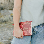 Model holding the Desert Sol Floral Gesture hardcover notebook in Ember Floral