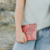 Model holding the Desert Sol Floral Gesture hardcover notebook in Ember Floral