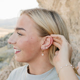 Model wearing the Desert Sol Everflight Butterfly Necklace in Petal Pink with Petal Hoop Earrings and Petal Studs