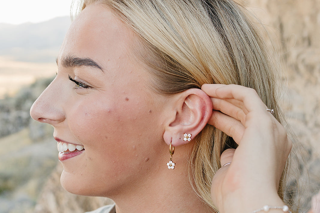 Model wearing the Desert Sol Everflight Butterfly Necklace in Petal Pink with Petal Hoop Earrings and Petal Studs