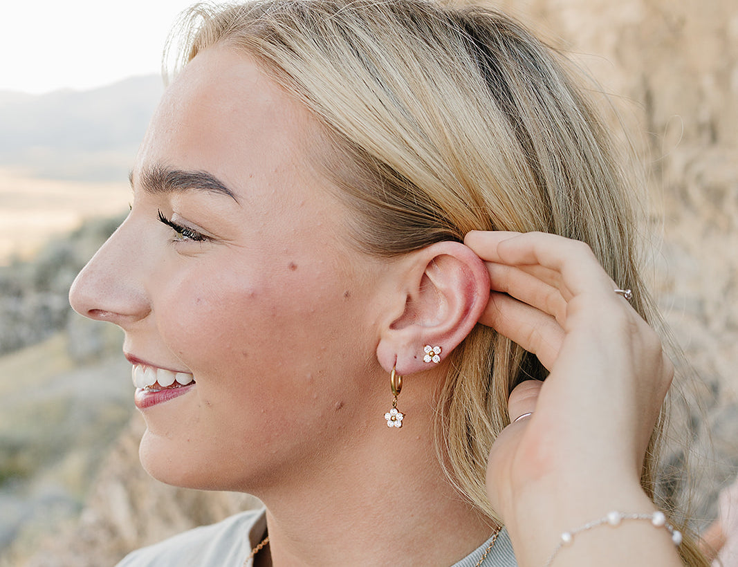 Model wearing the Desert Sol Everflight Butterfly Necklace in Petal Pink with Petal Hoop Earrings and Petal Studs