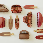 Desert Sol acrylic hair clips in Garnet, Roman Clay and Ember Floral laid out together