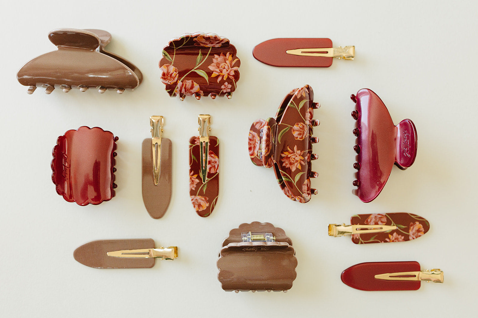 Desert Sol acrylic hair clips in Garnet, Roman Clay and Ember Floral laid out together