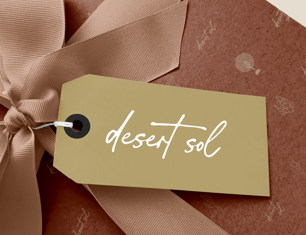 Desert Sol gift wrapping with terracotta paper, a satin ribbon bow and a Desert Sol tag