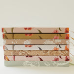 Stack of Desert Sol hardcover notebooks showing the floral spines and ribbon bookmarks