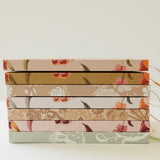 Stack of Desert Sol hardcover notebooks showing the floral spines and ribbon bookmarks