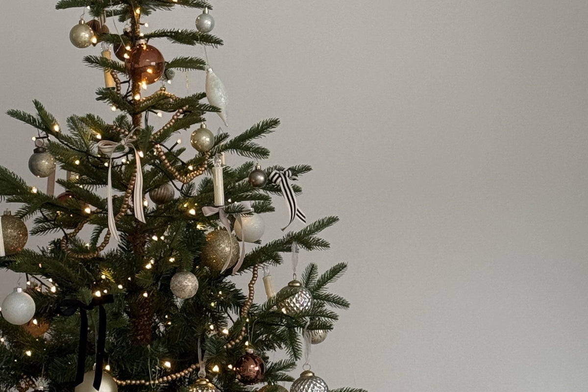 Christmas tree decorated with gold, blush and copper ornaments, ribbon bows and warm white lights for the Desert Sol Holiday Gift Guide
