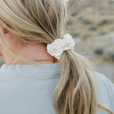 Low ponytail tied with the Desert Sol Mulberry Silk Scrunchie in Ivory