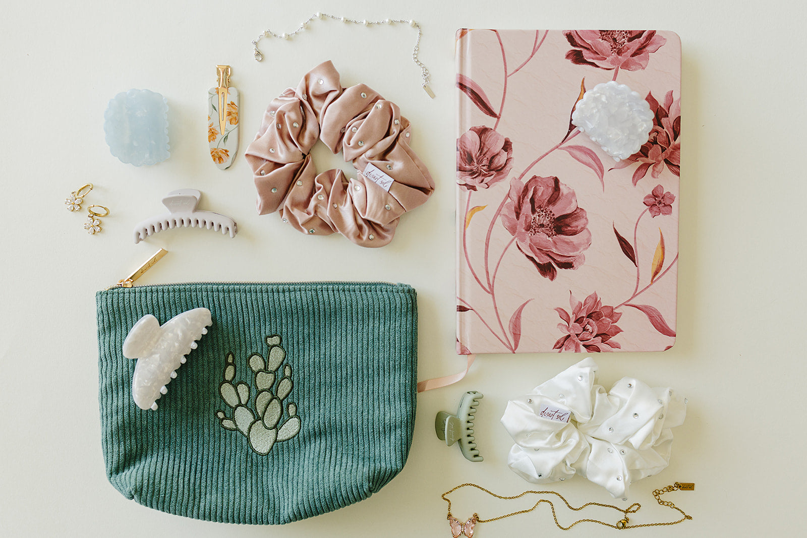 Desert Sol Mono Cactus corduroy pouch with a Mulberry Floral notebook, silk scrunchies, claw clips and jewelry