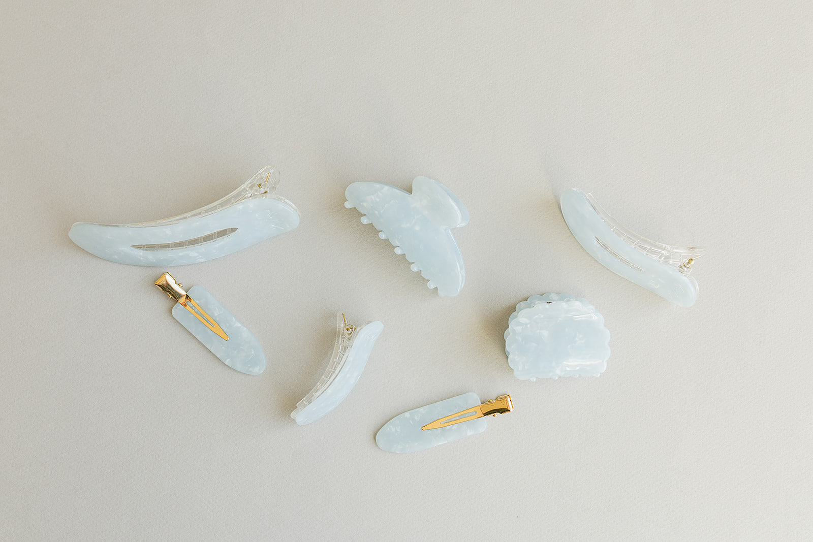 Desert Sol Moonstone acrylic hair clip set with an oval lay flat claw clip, classic claw clip, petal claw clip and snap clips in soft speckled blue