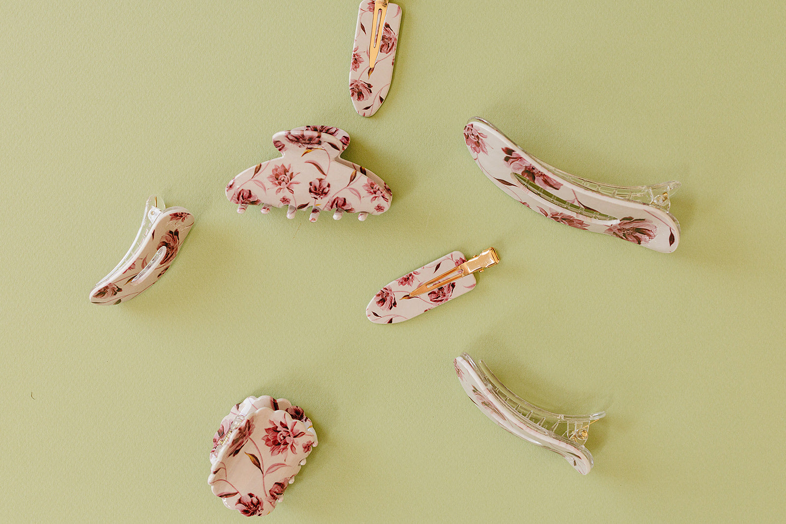 Desert Sol Mulberry Floral acrylic hair clip set with an oval lay flat claw clip, classic claw clip, petal claw clip and snap clips on a sage green background