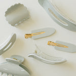 Desert Sol Muted Moss acrylic hair clip set with an oval lay flat claw clip, classic claw clip, petal claw clip and snap clips in soft gray green