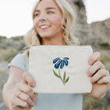 Model smiling and holding the Desert Sol Night Bloom corduroy flat pouch
