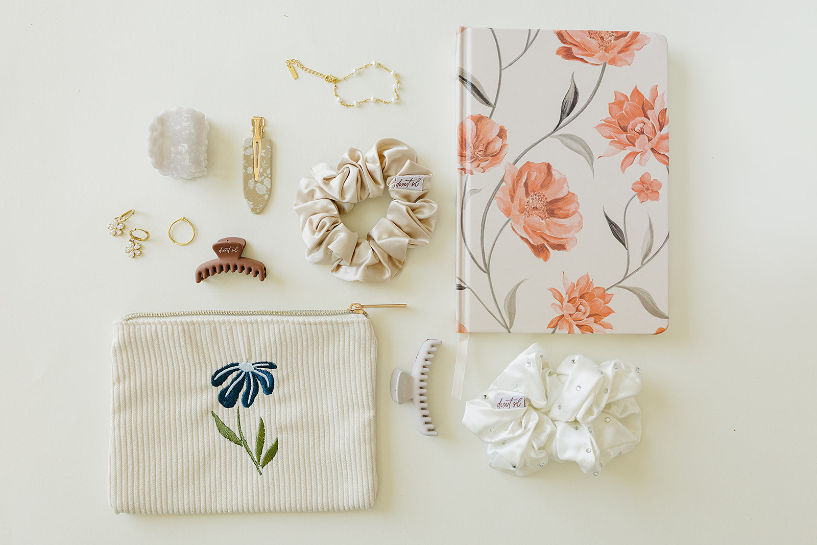 Desert Sol Night Bloom corduroy pouch with an Apricot Floral notebook, scrunchies, claw clips and gold jewelry