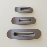 Desert Sol Oval Lay Flat Matte Claw Clip in Grey Lilac, shown in Mini, Standard and Classic sizes