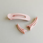 Desert Sol Oval Lay Flat Matte Claw Clip in Light Pink with matching hair accessories on a gray background