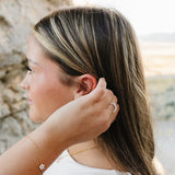 Model wearing the Desert Sol Petal Bracelet with a crystal white flower