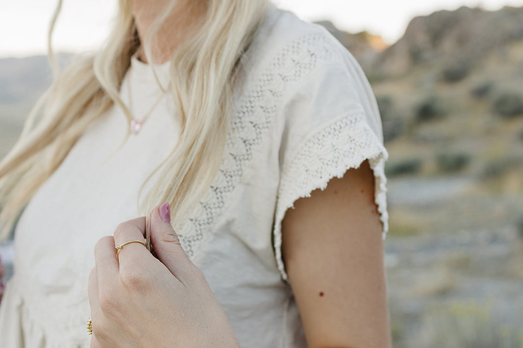 Model wearing the Desert Sol Petal Bracelet with a purple crystal flower