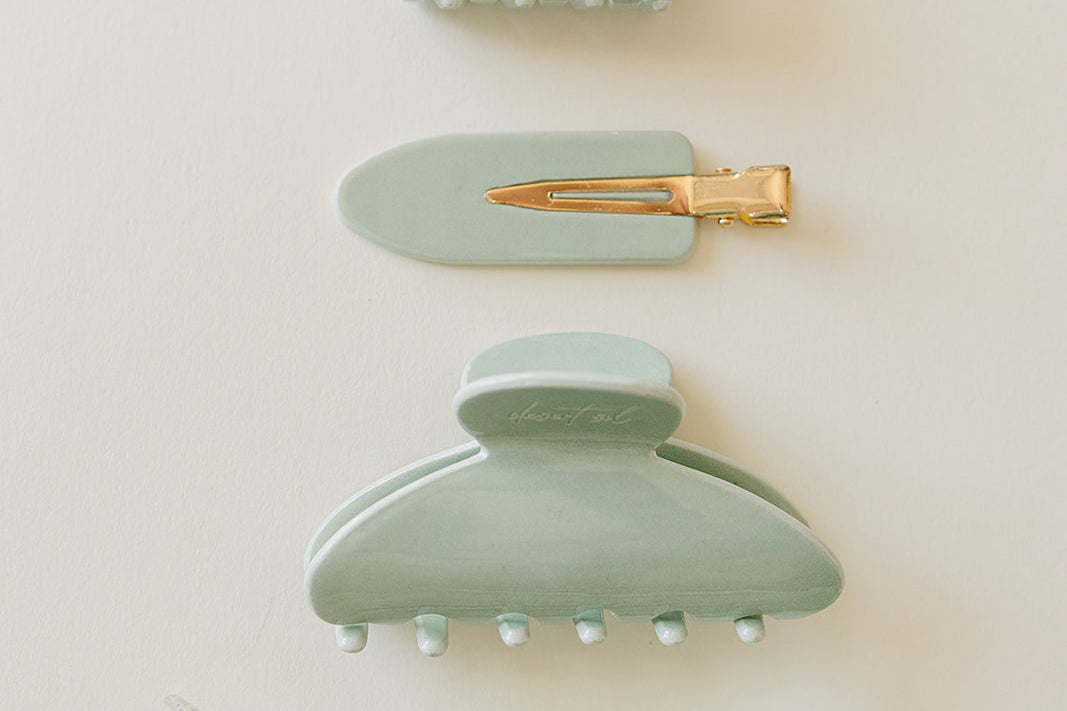 Desert Sol Soft Sage acrylic hair clip set with an oval lay flat claw clip, classic claw clip, petal claw clip and snap clips in pale mint