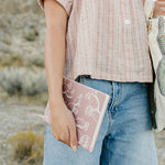 Model holding the Desert Sol Wild Bloom vegan leather journal in pink