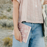 Model holding the Desert Sol Wild Bloom vegan leather journal in pink