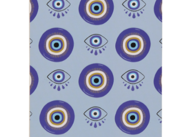 A Dopo Eye Twin Wire Notepad, a cream notepad with a repeating eye motif in blue and gold and a gold twin wire spiral across the top