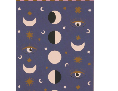A Dopo Moon Phases Twin Wire Notepad, a deep purple notepad with moon phases, eyes and stars in cream and gold under a striped header band