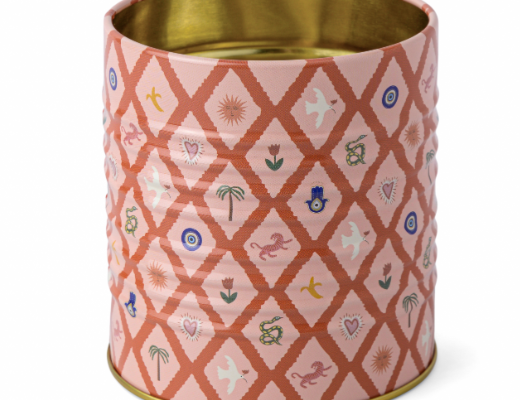 A Dopo Tin Icons, a pink tin pencil cup with a terracotta lattice and small symbols set inside it, and a gold interior