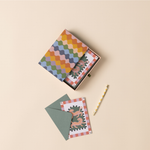 Designworks Notecards Set of 16, open patterned box with a folk-art card, green envelope and gold pen