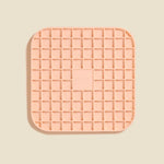 DOG by Dr Lisa DOG Lick Mat in Blush, a peach silicone mat with a waffle grid texture