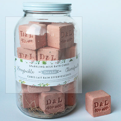 Dot & Lil Honeysuckle Sparkling Milk Bath Cubes, pink bath cubes stamped D&L in a glass jar
