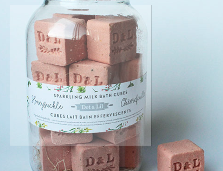 Dot & Lil Honeysuckle Sparkling Milk Bath Cubes, pink bath cubes stamped D&L in a glass jar