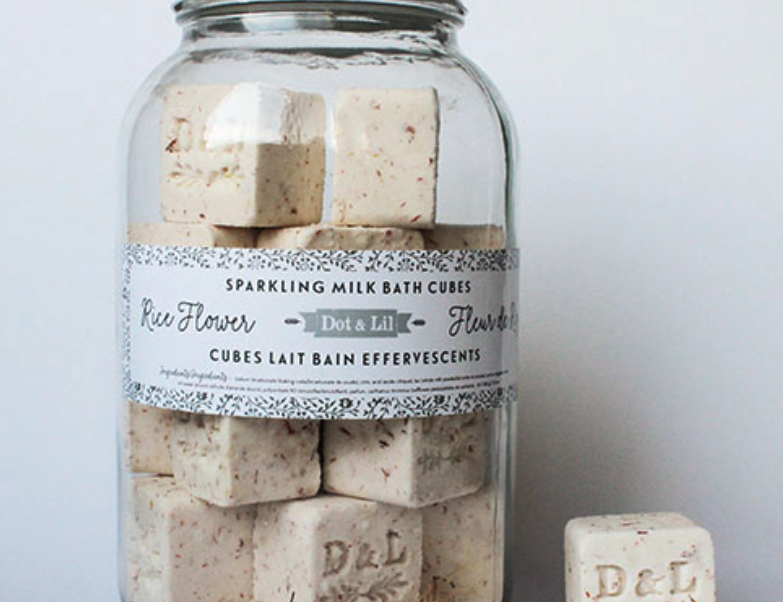 Dot & Lil Rice Flower Sparkling Milk Bath Cubes, cream cubes stamped D&L in a large glass jar