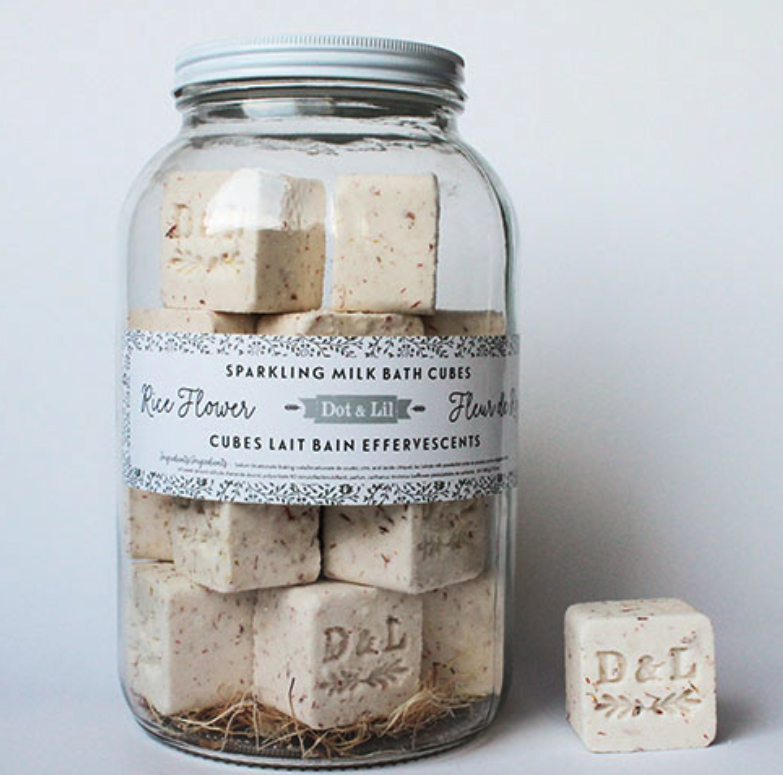 Dot & Lil Rice Flower Sparkling Milk Bath Cubes, cream cubes stamped D&L in a large glass jar