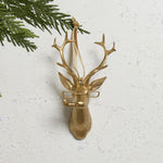 E + E Ornaments, third view, the gold buck with spectacles hanging on a cedar branch