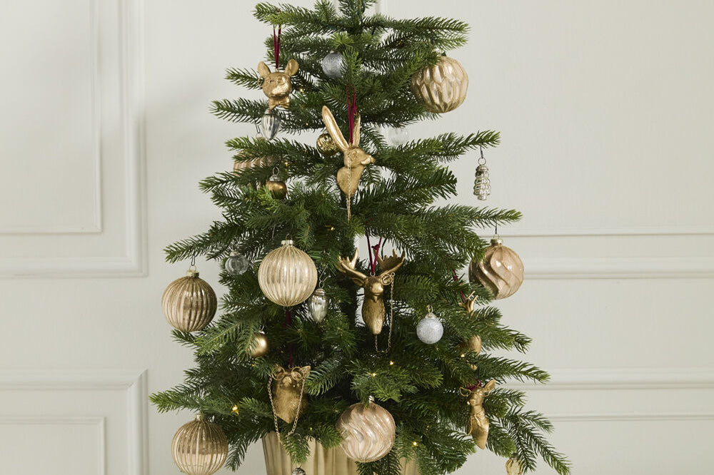 E + E Ornaments, second view, a small Christmas tree in a gold pot decorated with gold ornaments
