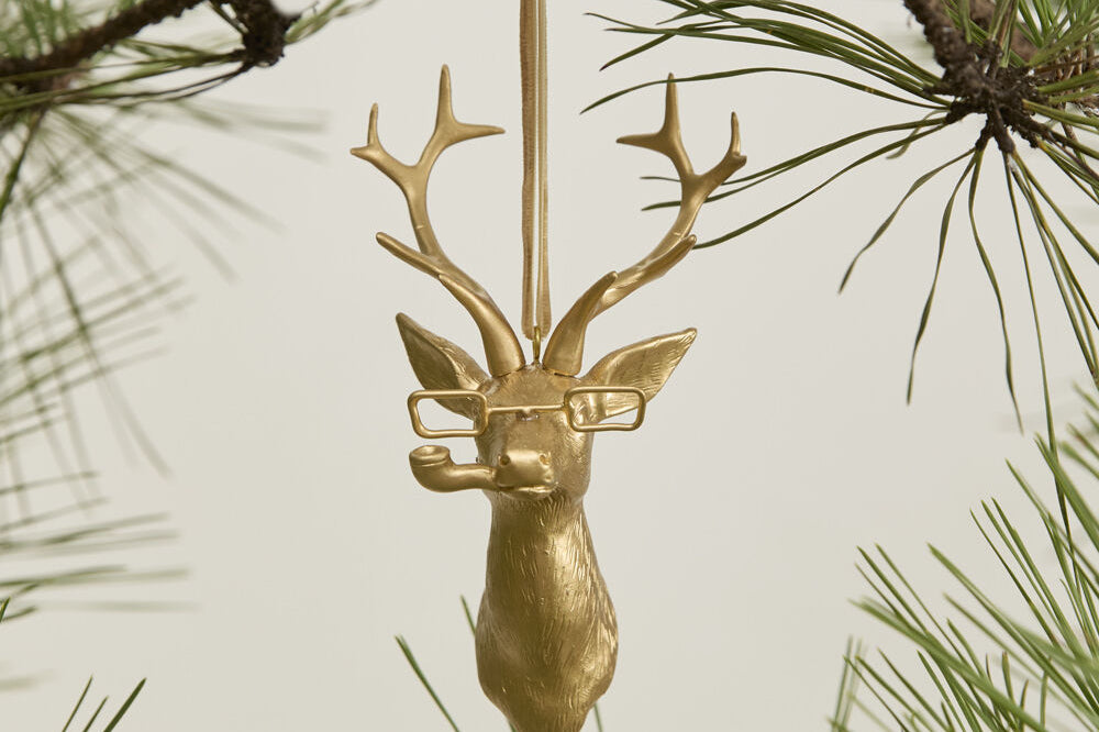 E + E Ornaments, fifth view, the gold buck hanging from a pine branch