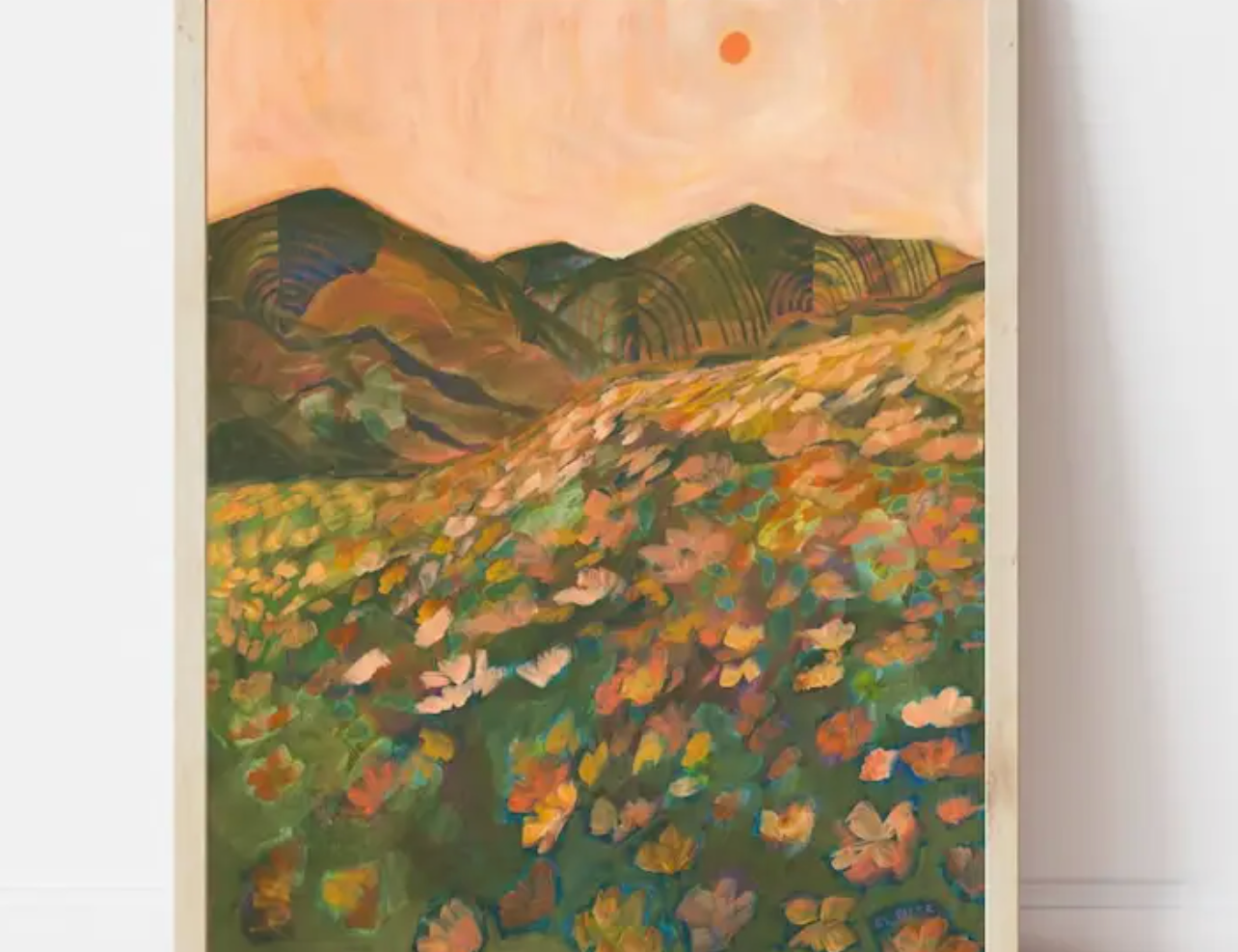 El Baker Art Pastel California Poppy Flower Print, a painted hillside of poppies in a wood frame leaning against a wall