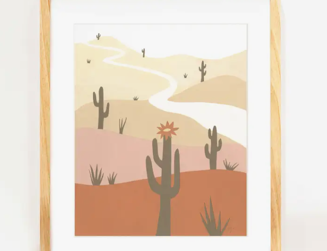 Elana Gabrielle Saguaro Print, a minimalist desert illustration with saguaros and a winding road, in a wood frame