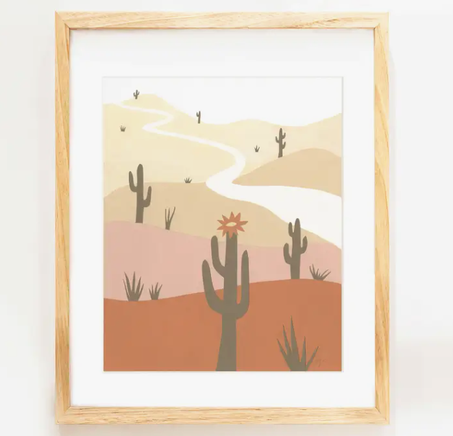 Elana Gabrielle Saguaro Print, a minimalist desert illustration with saguaros and a winding road, in a wood frame