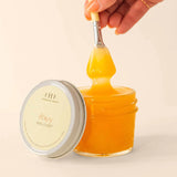 Farmhouse Fresh Honey Heel Glaze, a jar of golden honey glaze dripping from a brush