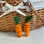 Two Foggy Dog Cat Toy felt carrots with smiling faces in a wicker basket