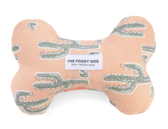 Foggy Dog Dog Squeaky Toy in Cactus Garden, a peach plush bone with a sage cactus print