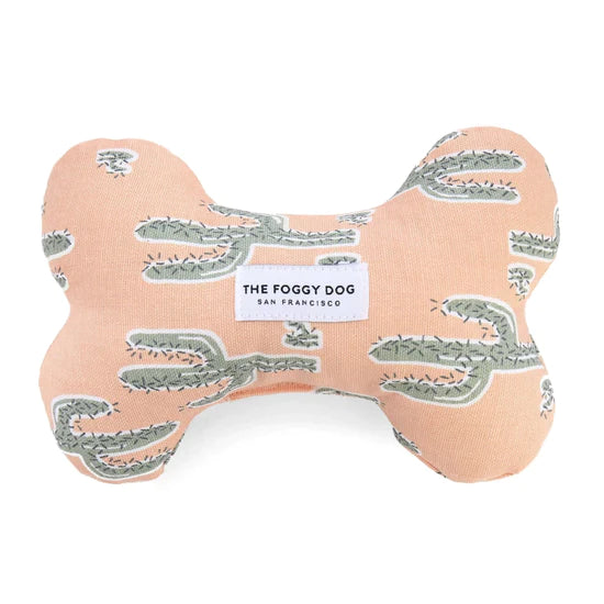 Foggy Dog Dog Squeaky Toy in Cactus Garden, a peach plush bone with a sage cactus print