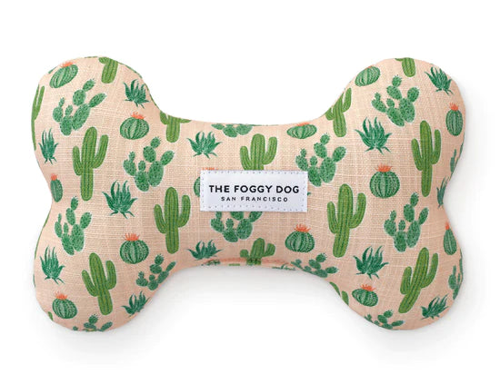 Foggy Dog Dog Squeaky Toy in Desert Cactus, a blush plush bone with a green cactus print