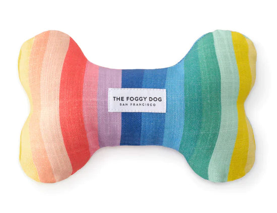 Foggy Dog Dog Squeaky Toy in Over The Rainbow, a plush bone with rainbow stripes