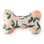 Foggy Dog Dog Squeaky Toy in Peaches and Cream, a plush bone with a peach and leaf print