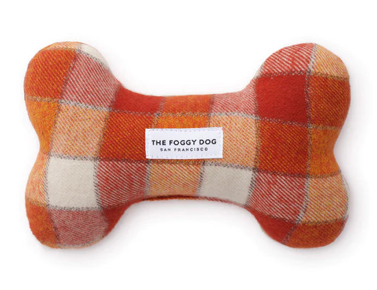 Foggy Dog Dog Squeaky Toy in Pumpkin Spice, a plush bone in orange and cream plaid flannel