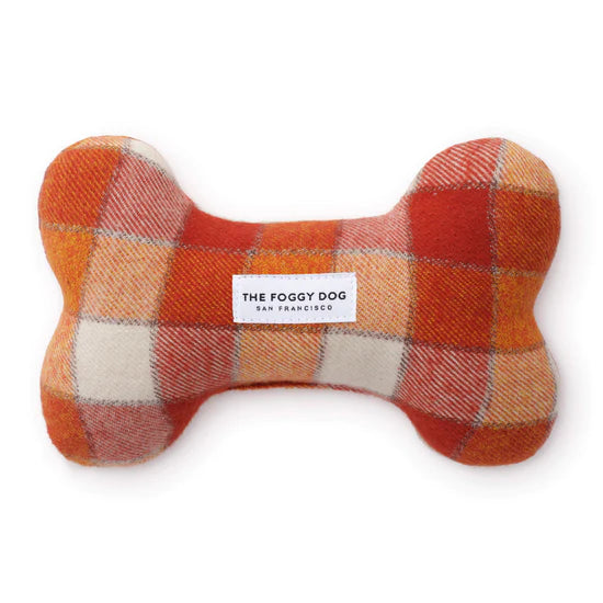 Foggy Dog Dog Squeaky Toy in Pumpkin Spice, a plush bone in orange and cream plaid flannel