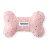 Foggy Dog Dog Squeaky Toy in Sprinkles, a pink plush bone with a colorful sprinkle print